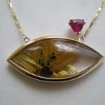 14k YG pendant, set with rutile star in quartz and rubellite. Design: Mark Lasater; fabrication Reese Patton. Photo courtesy Mark Lasater, The Clamshell. 2010.