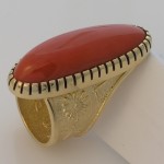 A perfect piece of red coral is all that is needed in this 18k yellow gold ring. Photo courtesy of the artist, Darryl Dean Begay.